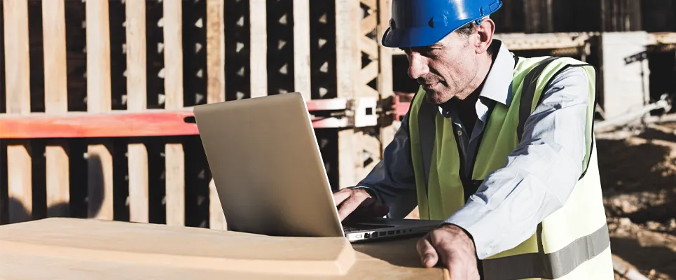 concrete estimator reviewing concrete formwork plans on a jobsite